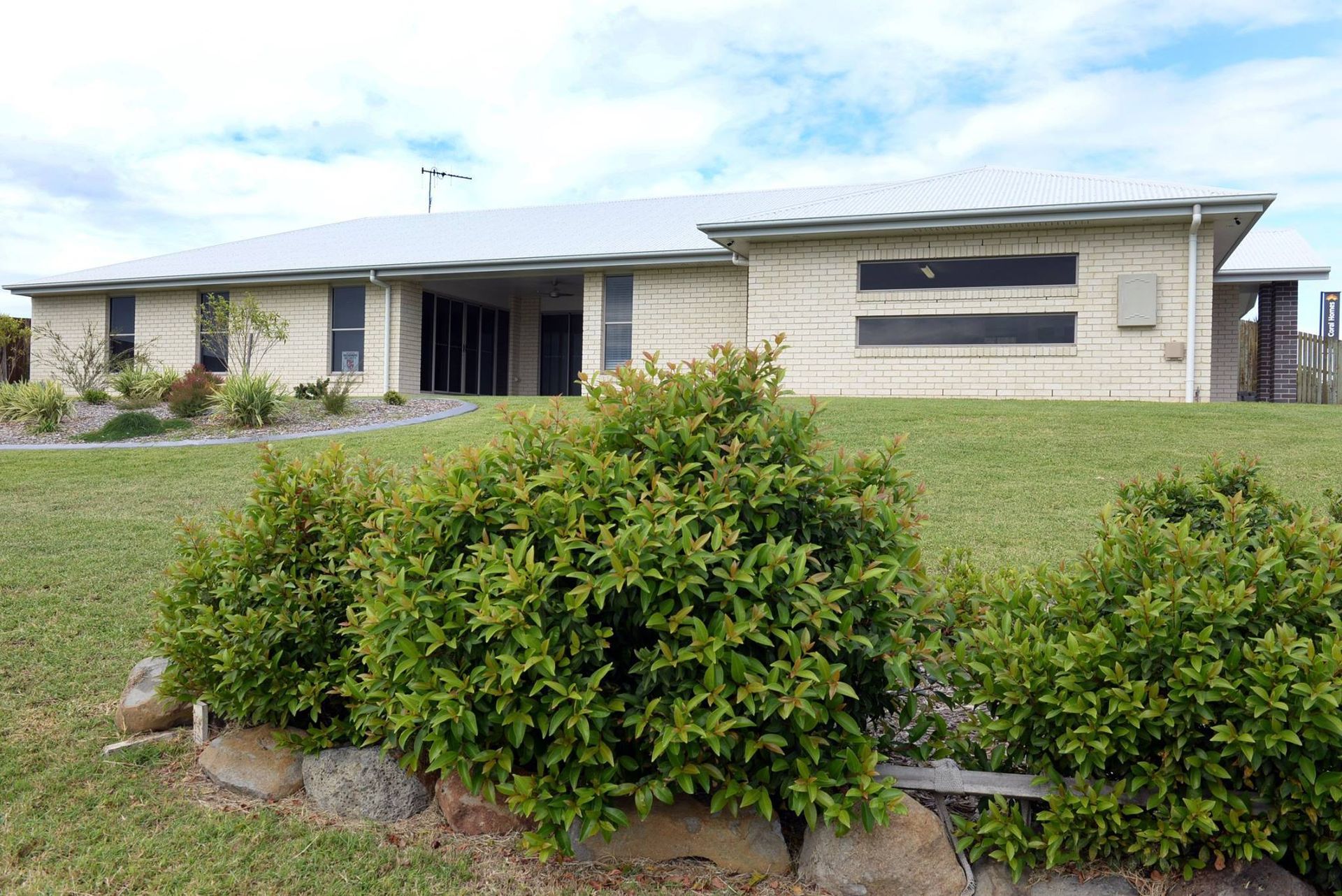Single-Story Stone Building with A Manicured Lawn — Bundy Homes in Bundaberg North, QLD