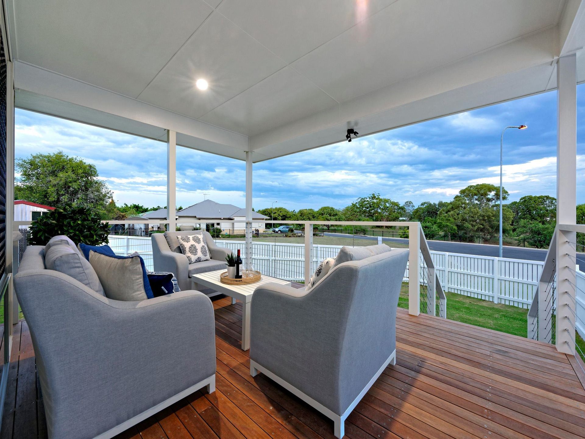 Covered Porch with Gray Chairs and A Small Table — Bundy Homes in Bundaberg North, QLD