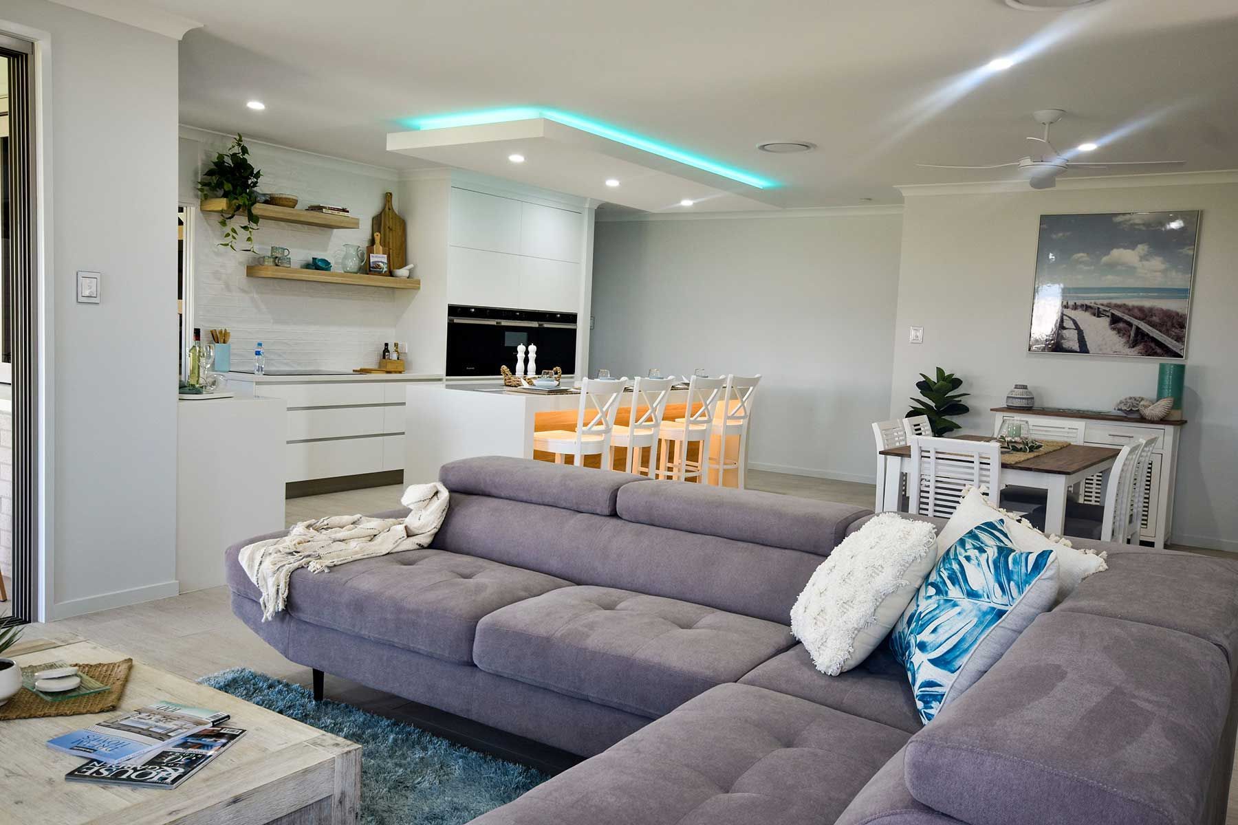 Modern Open-Plan Living Room with Gray Sectional Sofa — Bundy Homes in Bundaberg North, QLD