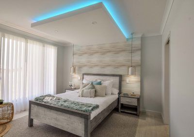 Bright Modern Bedroom with A Gray Bed — Bundy Homes in Bundaberg North, QLD