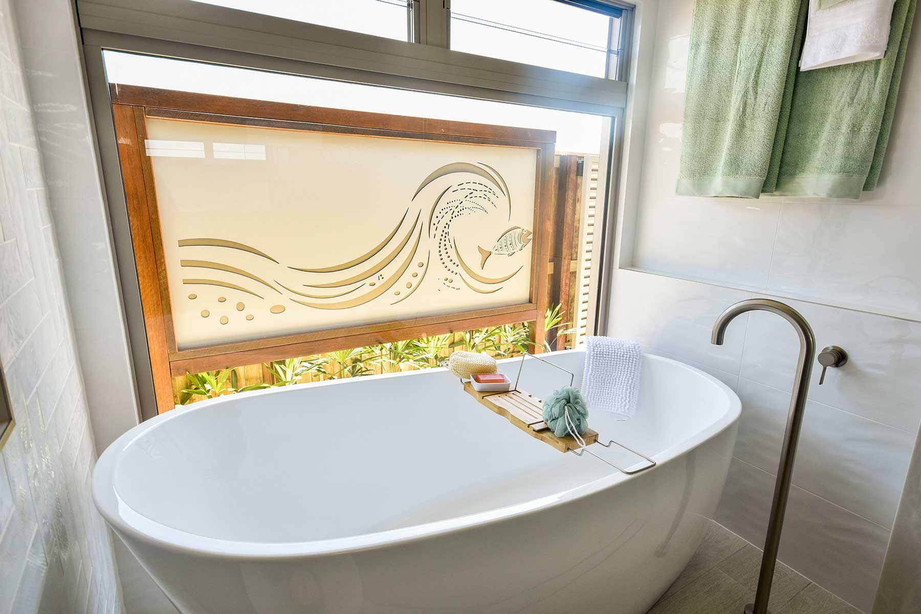 Bright Bathroom with A White Freestanding Tub — Bundy Homes in Bundaberg North, QLD