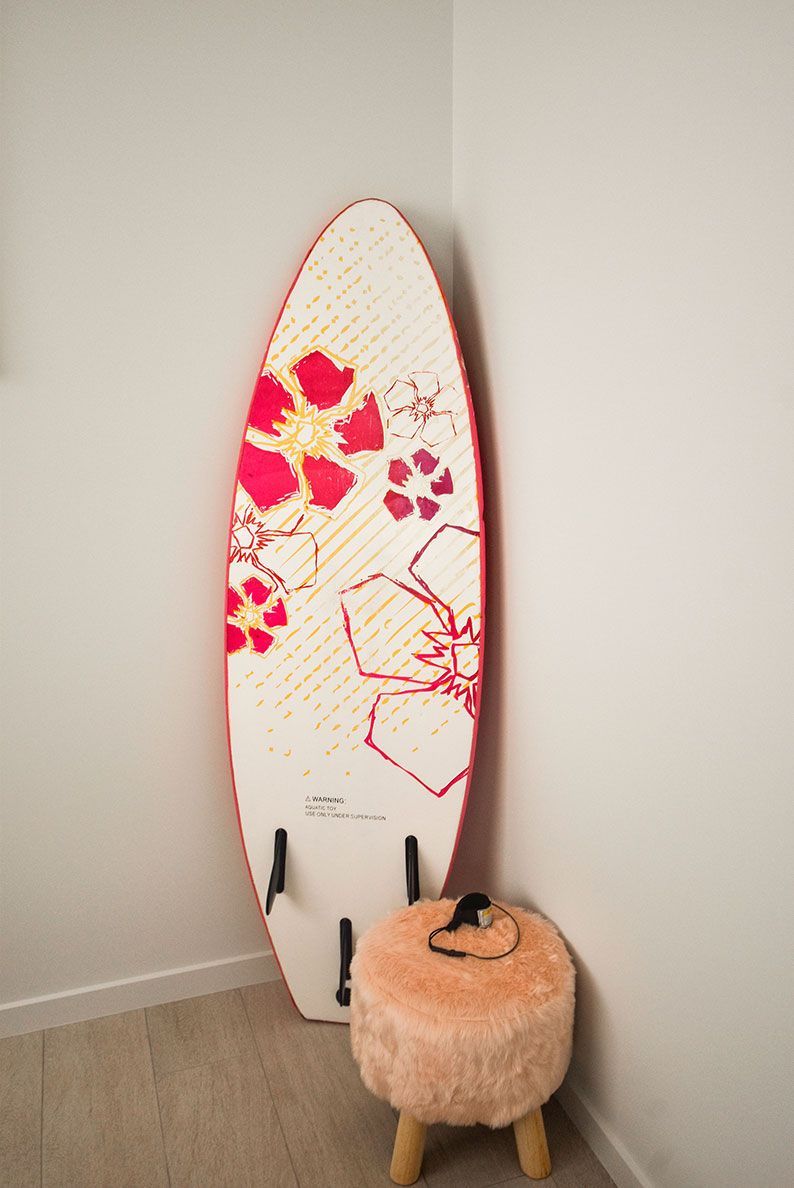 Surfboard with Pink Floral Design Leaning — Bundy Homes in Bundaberg North, QLD