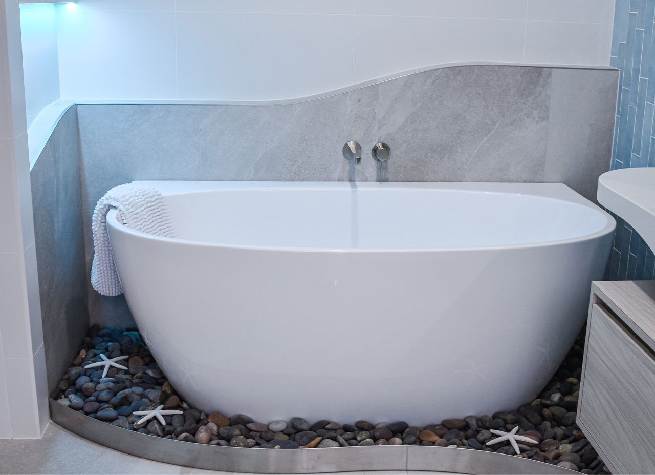 Modern White Freestanding Bathtub in A Minimalist Bathroom — Bundy Homes in Bundaberg North, QLD
