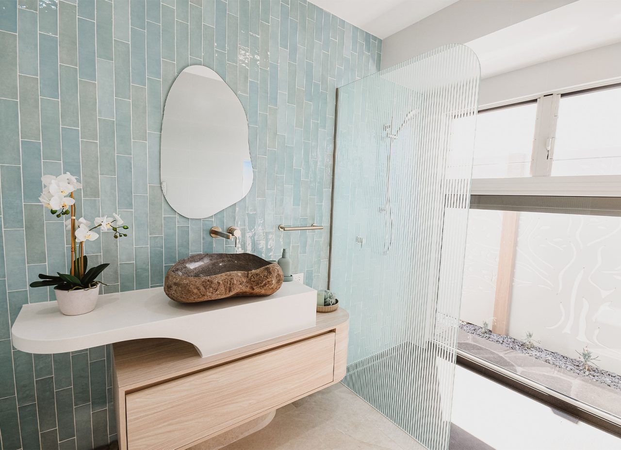 Modern Bathroom Vanity with Blue Textured Wall — Bundy Homes in Bundaberg North, QLD