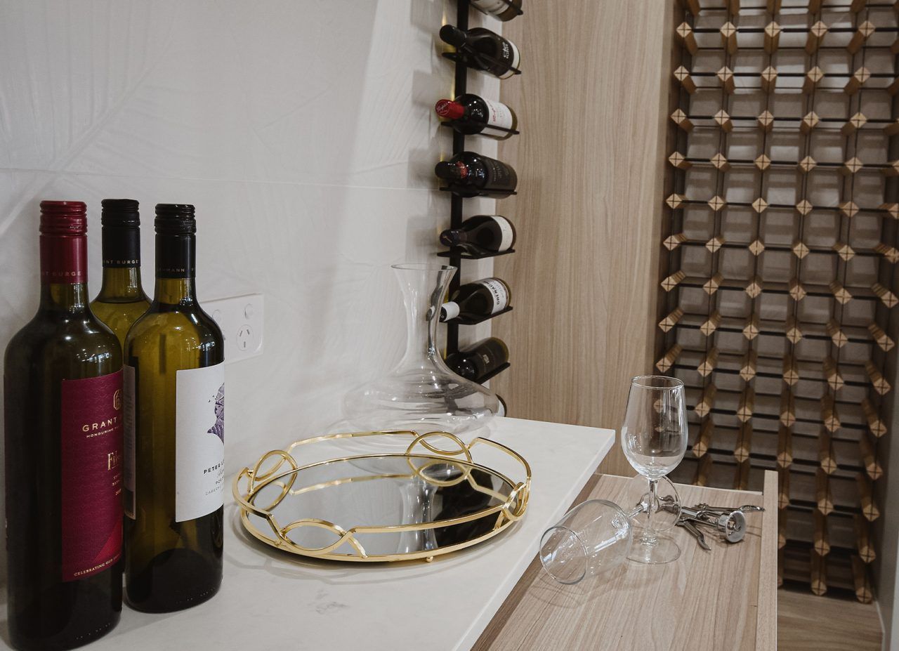 Wine Bottles and Glasses on A Table — Bundy Homes in Bundaberg North, QLD