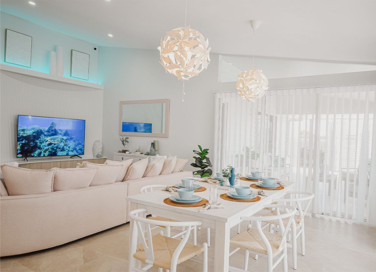 Bright White Dining and Living Room with A Sofa — Bundy Homes in Bundaberg North, QLD