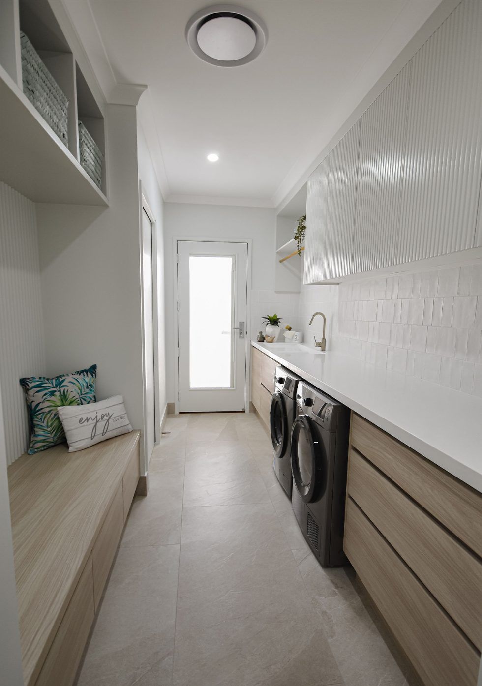 Narrow Modern Laundry Room with Stacked Washer-Dryer — Bundy Homes in Bundaberg North, QLD