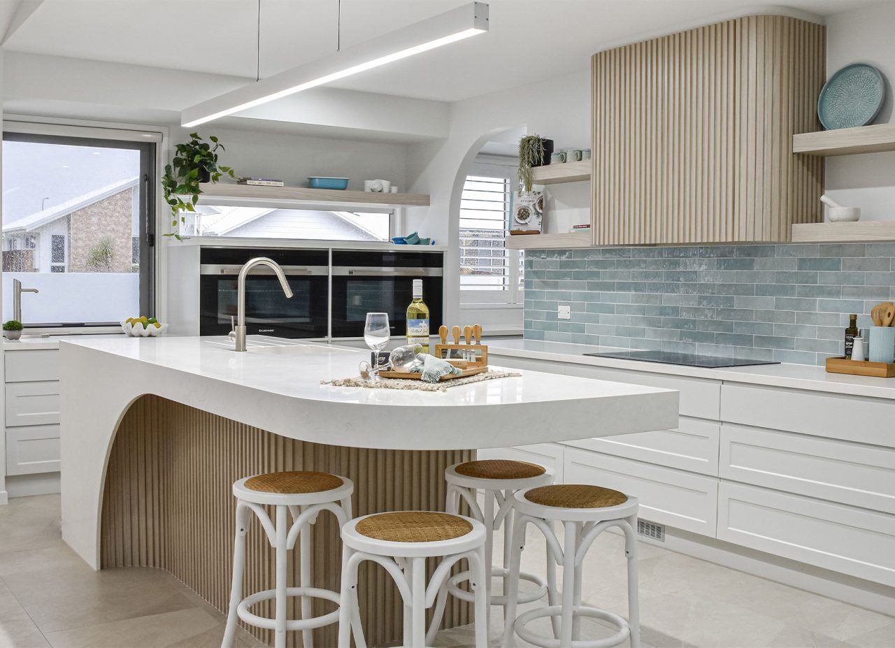 Bright Modern Kitchen with White Island and Blue Tile Backsplash — Bundy Homes in Bundaberg North, QLD