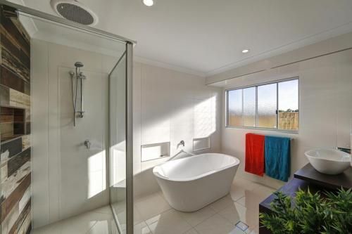 Bright Modern Bathroom with Walk-In Shower — Bundy Homes in Bundaberg North, QLD
