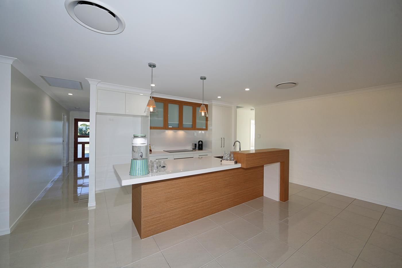 Bright Empty Modern Kitchen with White Cabinets — Bundy Homes in Bundaberg North, QLD
