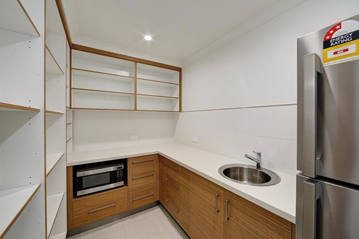 Compact Modern Kitchen with White Cabinets — Bundy Homes in Bundaberg North, QLD