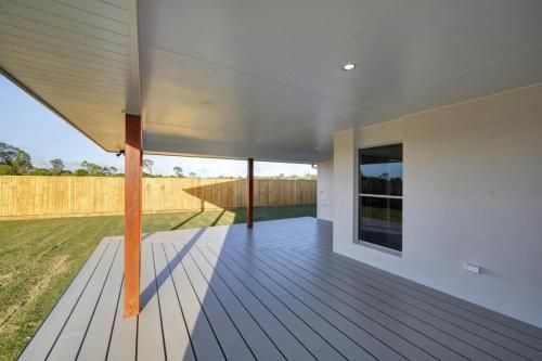 Covered Backyard Patio with White Decking — Bundy Homes in Bundaberg North, QLD