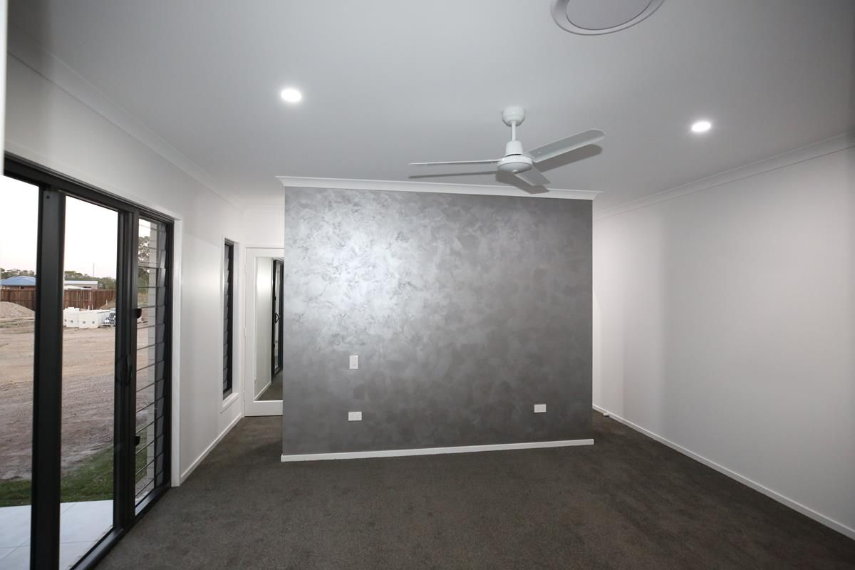 Empty Modern Room with Gray Accent Wall — Bundy Homes in Bundaberg North, QLD