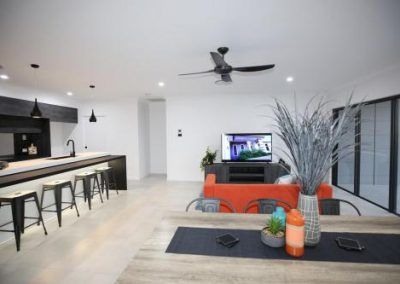 Modern Open-Plan Living Room with Kitchen Bar — Bundy Homes in Bundaberg North, QLD