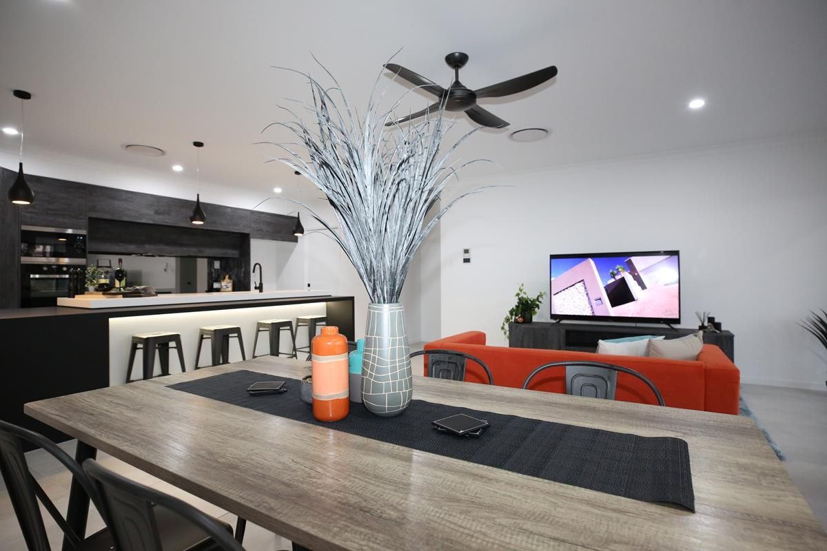 Modern Open-Plan Living Room with Orange Sofa — Bundy Homes in Bundaberg North, QLD