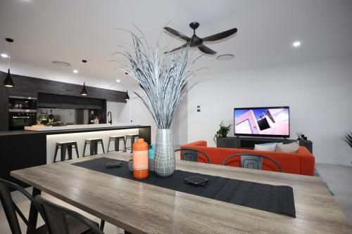 Modern Open-Plan Living Room with Orange Sofa — Bundy Homes in Bundaberg North, QLD