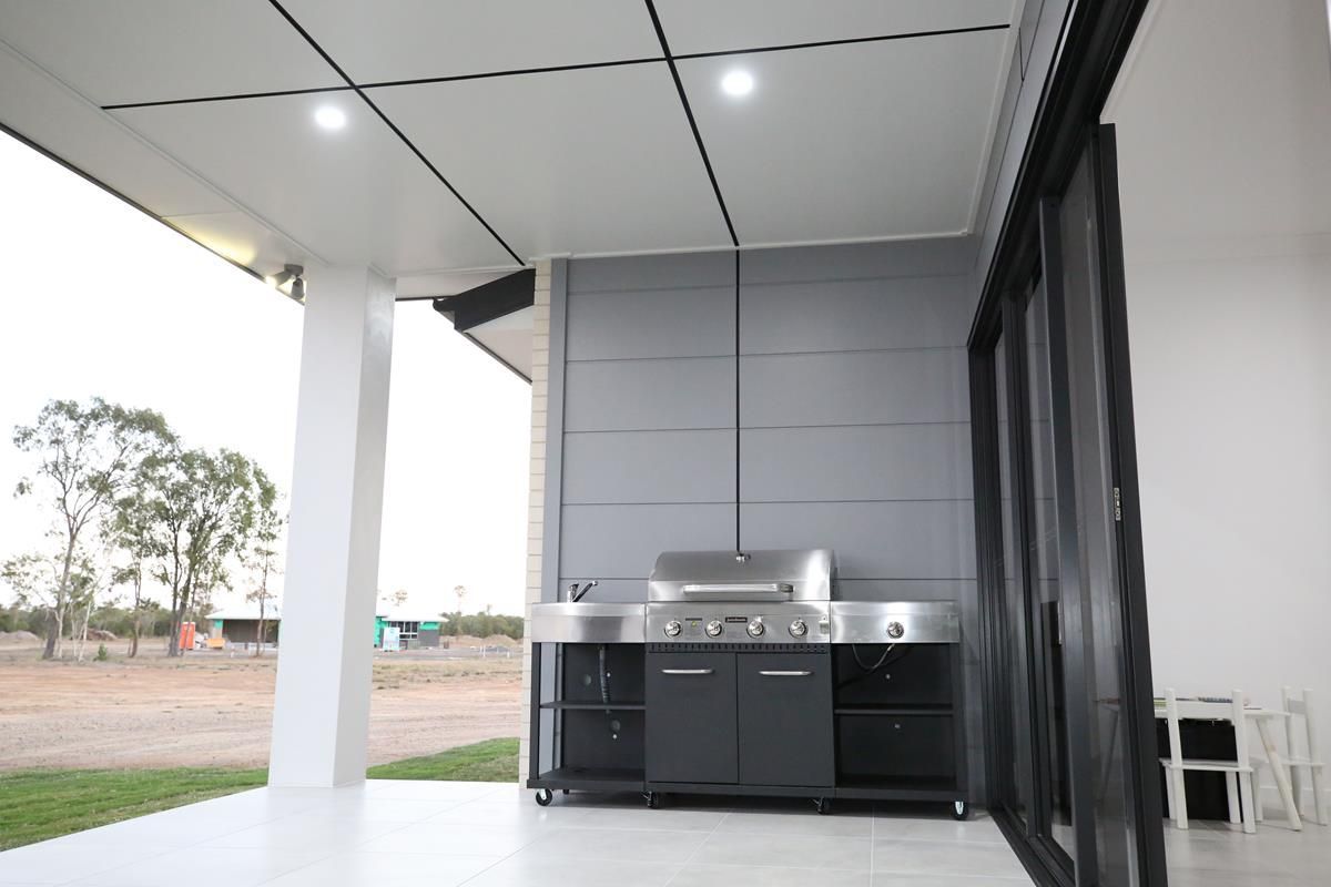 Covered Patio with A Black Outdoor Kitchen — Bundy Homes in Bundaberg North, QLD