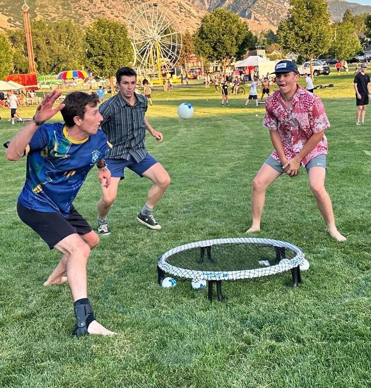 Teenagers playing in a spikeball tournament with Premier Spike