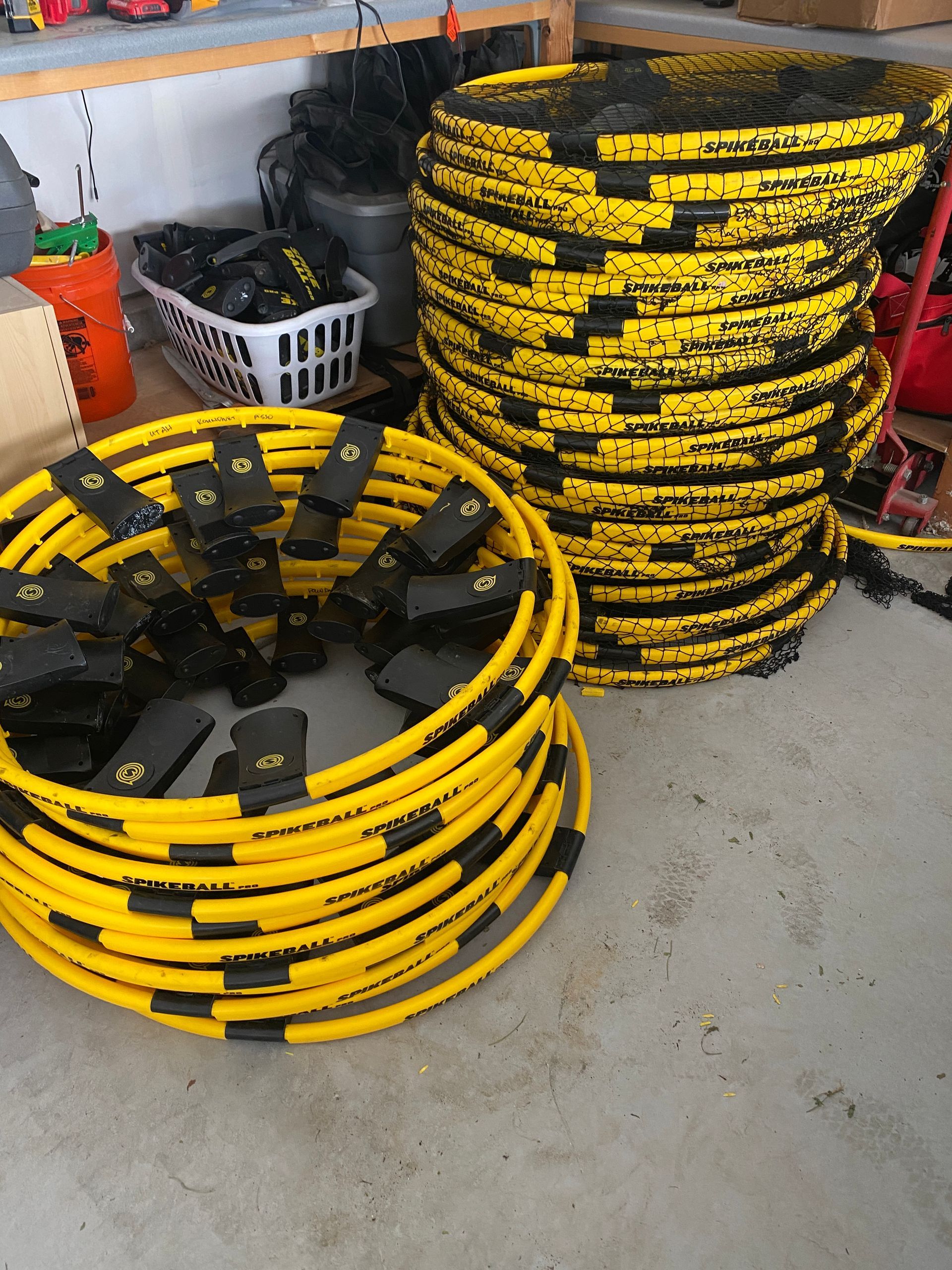Yellow and black protective hose covers stacked and coiled in a garage setting.