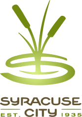 Logo of Syracuse City: stylized cattails over a green “S” shape, with “Syracuse City” and “Est. 1935” below.