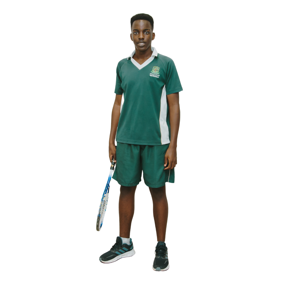 A young man in a green shirt and shorts is holding a tennis racquet.