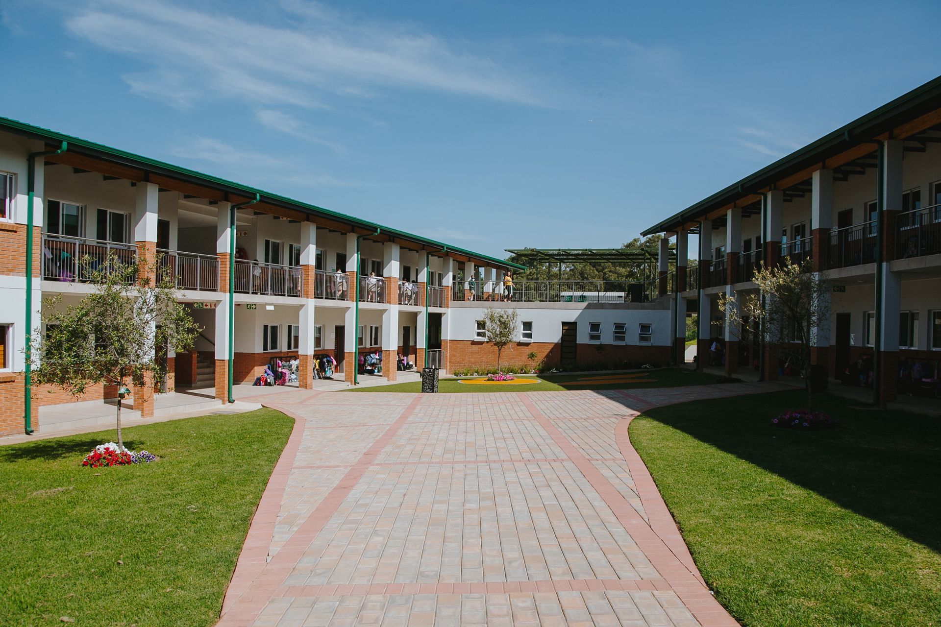 A large building with a brick walkway leading to it.