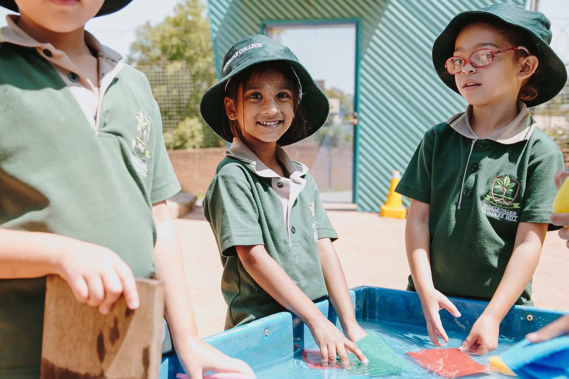 A group of children are playing in a sandbox.