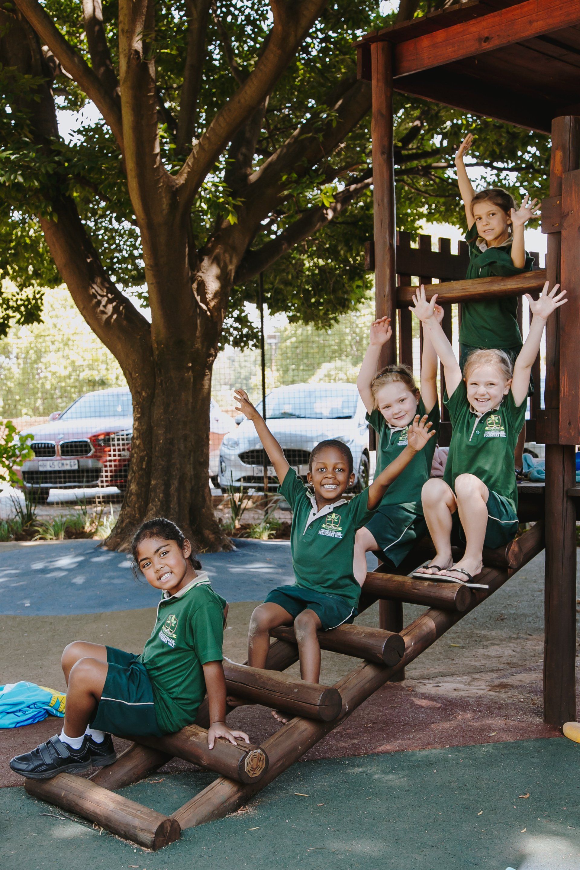 A group of children are playing on a wooden playground