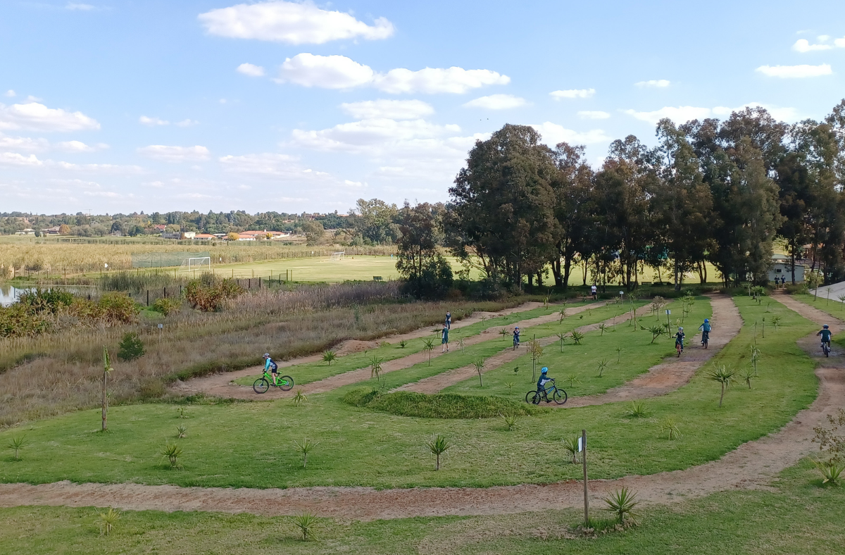 A group of people are riding bikes on a grassy field.