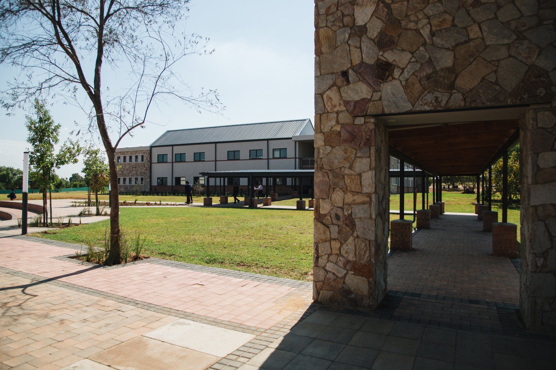 A stone building with a covered walkway leading to it