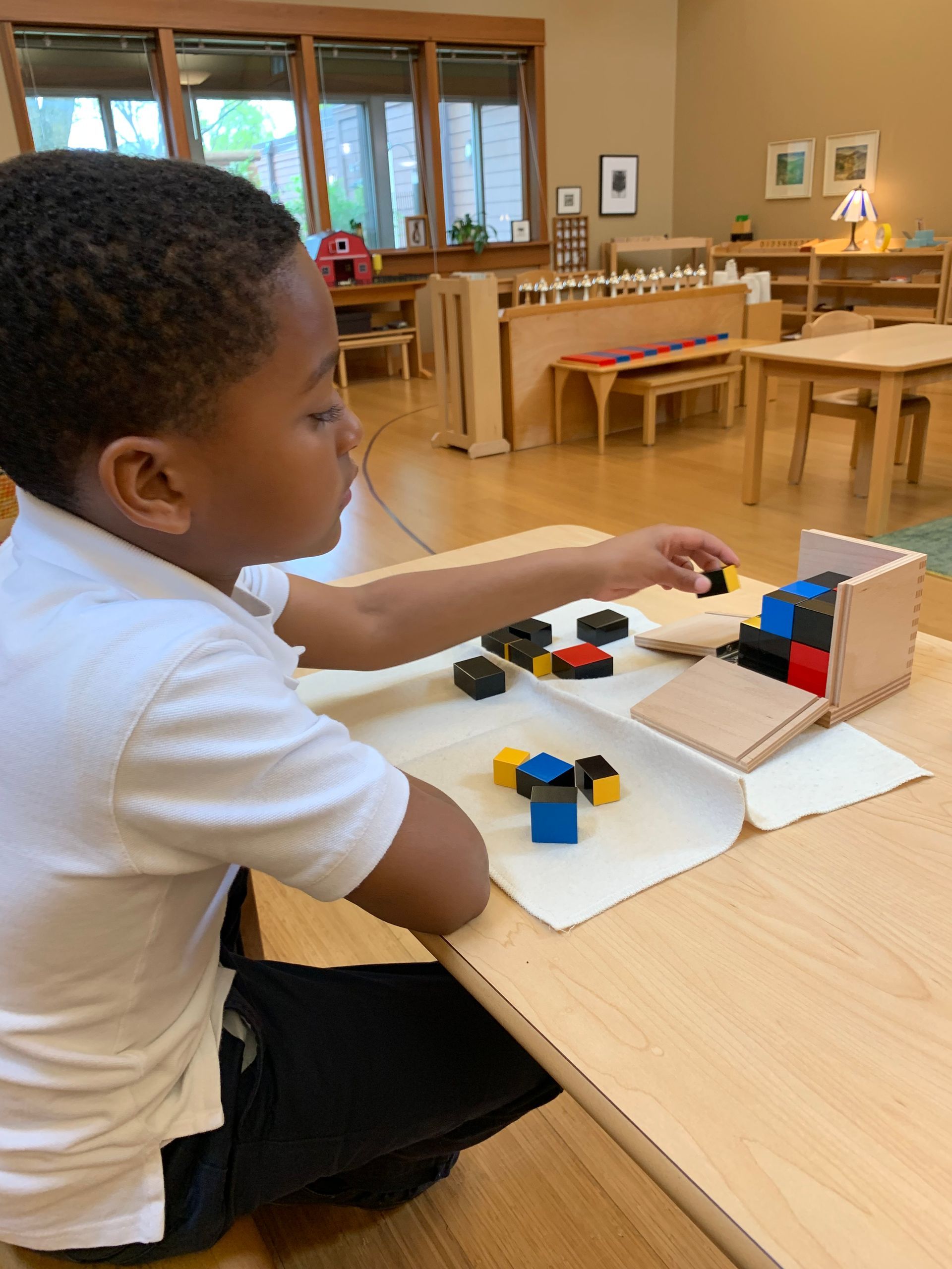 Montessori children of different ages seating on a dock