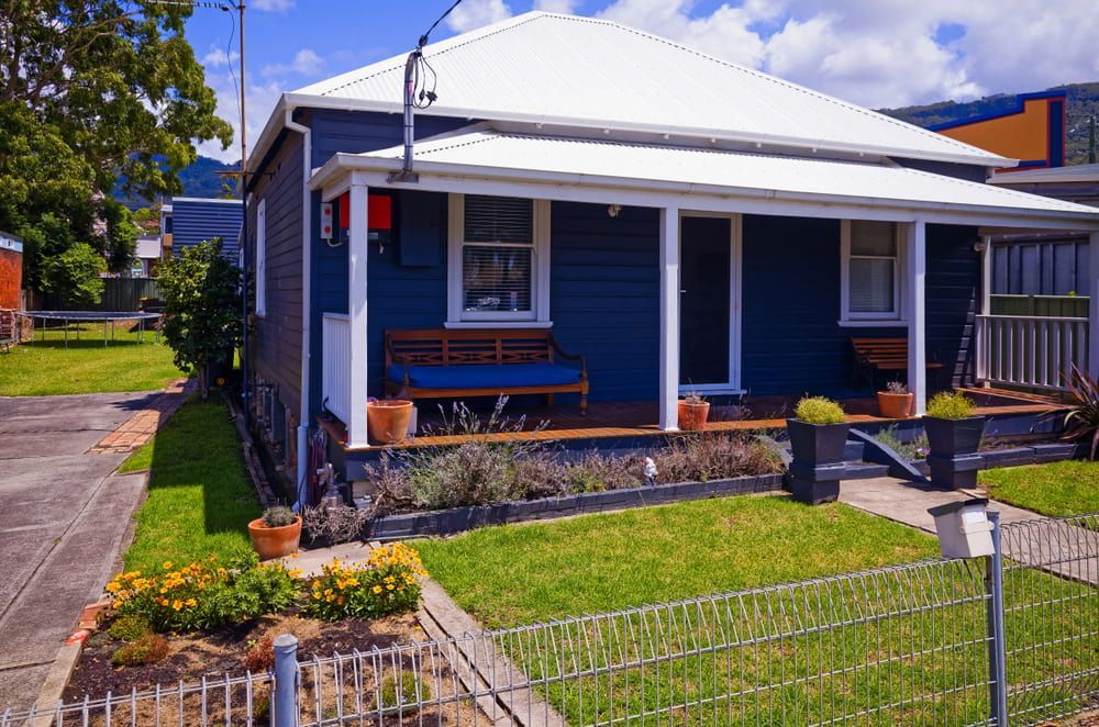 A Blue House with A White Roof and A Porch — Croker Building Solutions In Myrtleville, NSW
