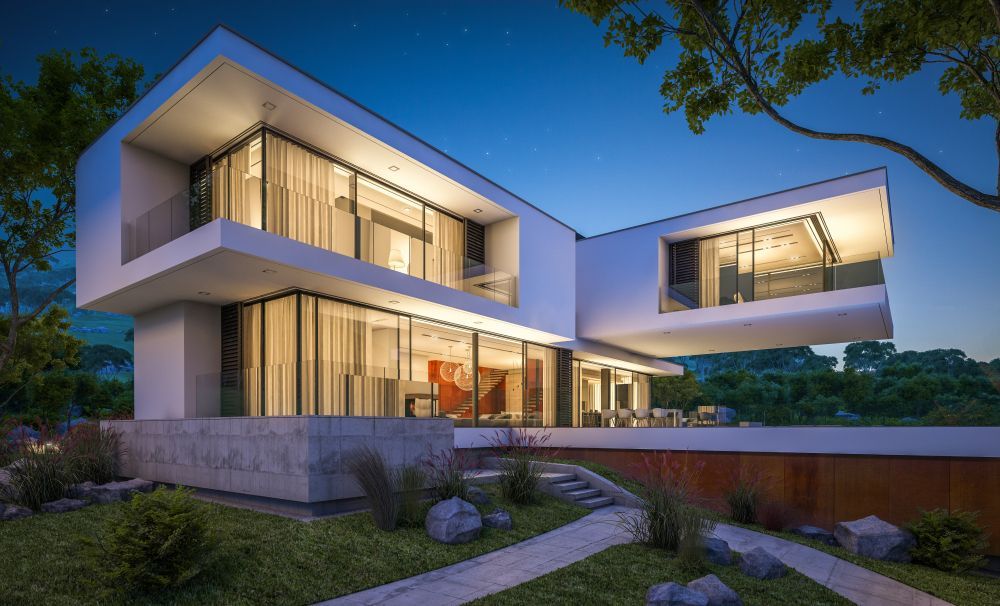 A Modern House with A Lot of Windows Is Lit up At Night — Croker Building Solutions In Myrtleville, NSW