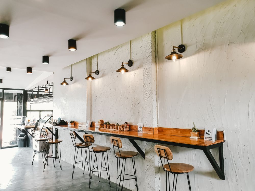 There Are a Lot of Tables and Chairs in This Restaurant — Croker Building Solutions In Myrtleville, NSW