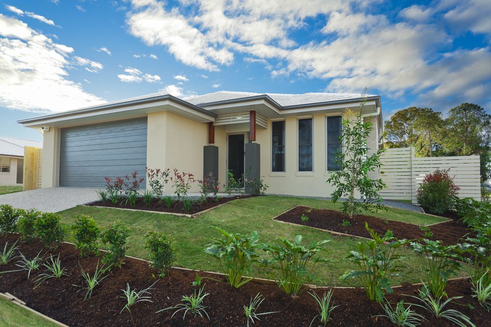 A House with A Large Garage and A Lush Green Yard — Croker Building Solutions In Myrtleville, NSW