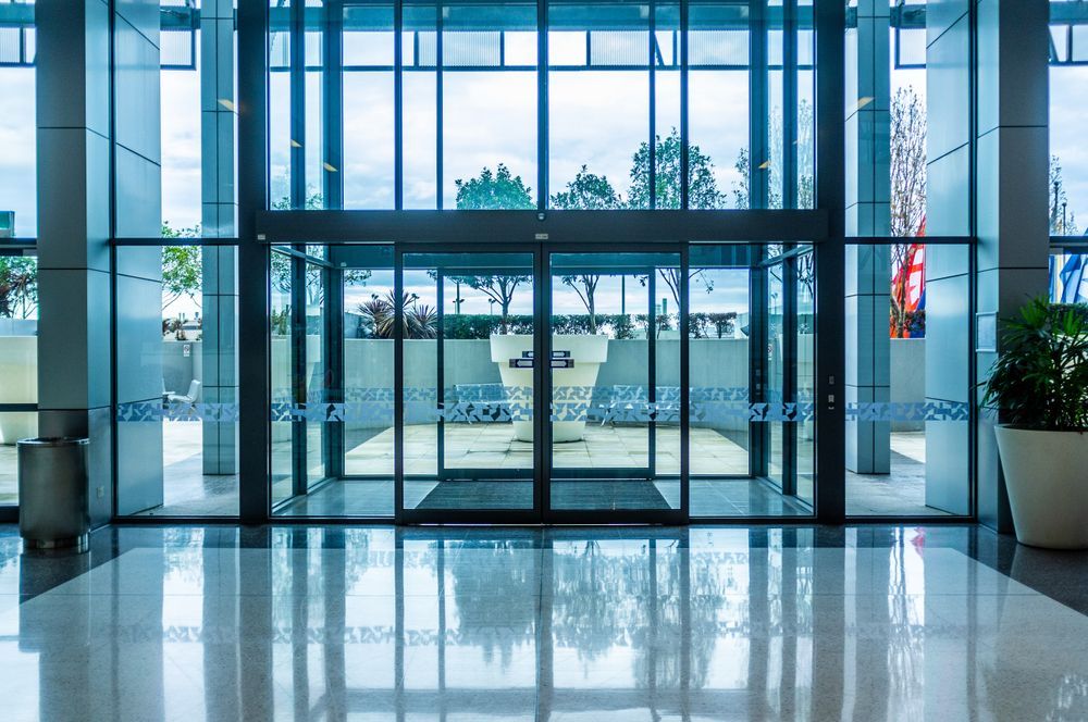 A Large Building with A Lot of Windows and A Sliding Glass Door — Croker Building Solutions In Myrtleville, NSW