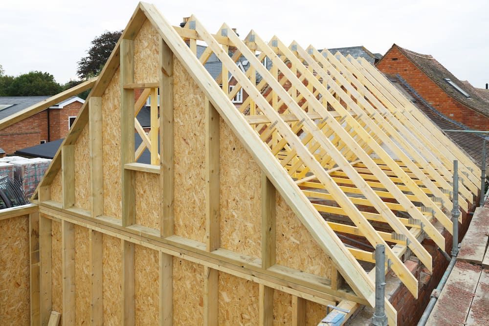 The Roof of A House Is Being Built with Wooden Beams — Croker Building Solutions In Myrtleville, NSW