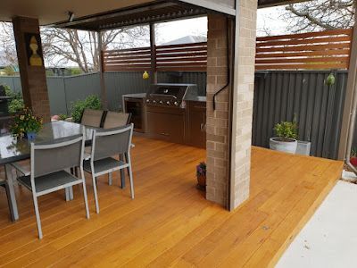 A wooden deck with a table and chairs and a grill. — Croker Building Solutions In Myrtleville, NSW