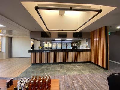 A large room with a wooden counter and bottles on a table. — Croker Building Solutions In Myrtleville, NSW