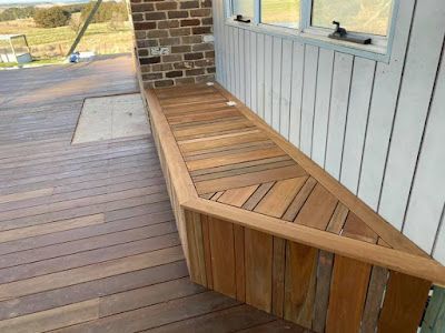 A wooden bench on a deck next to a window. — Croker Building Solutions In Myrtleville, NSW