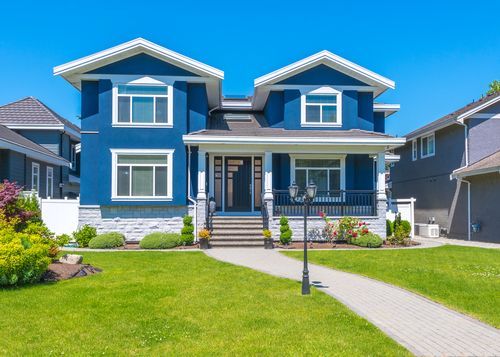 A Large Blue and White House with A Large Lawn in Front of It — Croker Building Solutions In Myrtleville, NSW