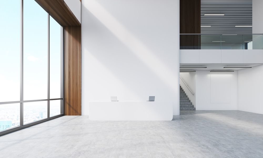 A Large Empty Room with A Lot of Windows and Stairs — Croker Building Solutions In Myrtleville, NSW