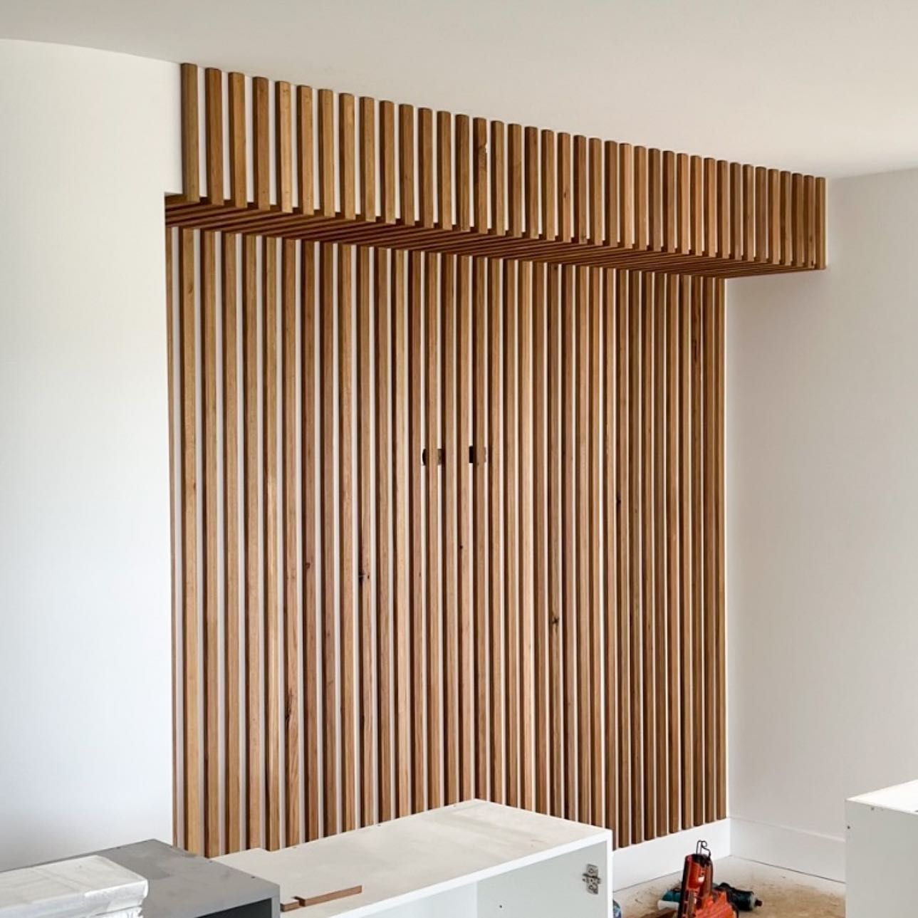 A room with a wooden wall and cabinets — Croker Building Solutions In Myrtleville, NSW