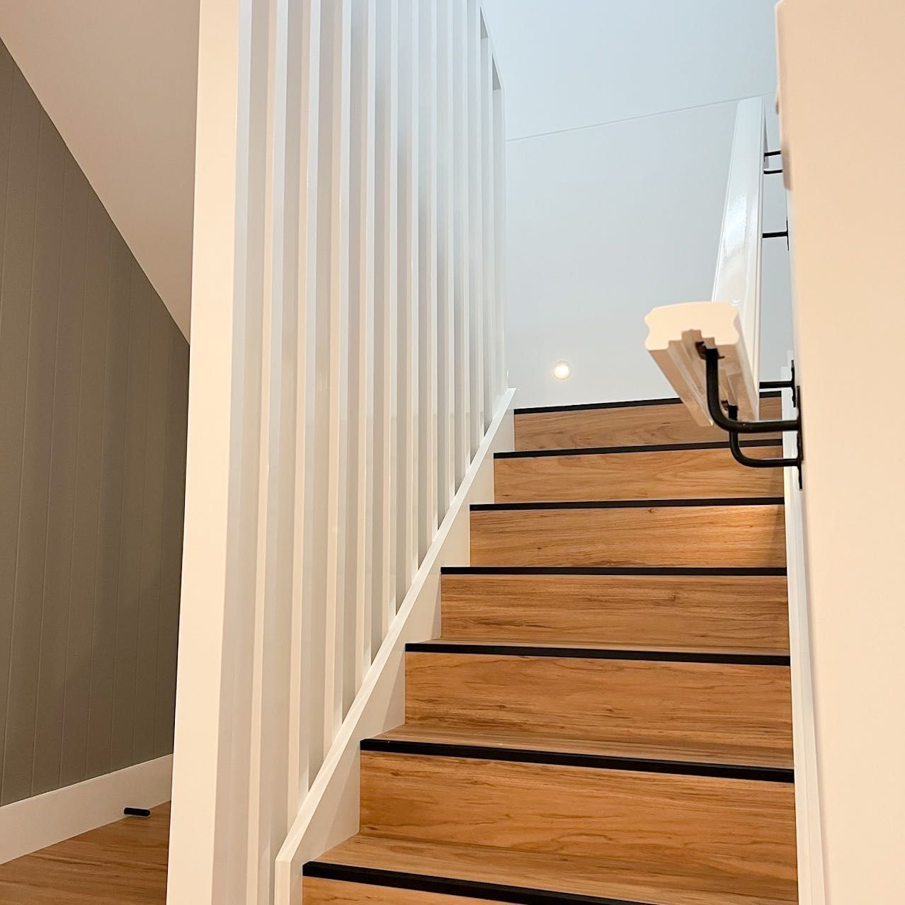 A staircase with wooden steps and a white railing — Croker Building Solutions In Myrtleville, NSW