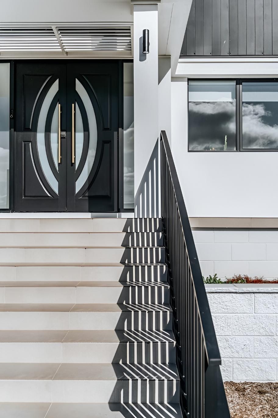 Modern Home Entrance With Steps, Black Door, and Metal Railing — Croker Building Solutions In Moss Vale, NSW