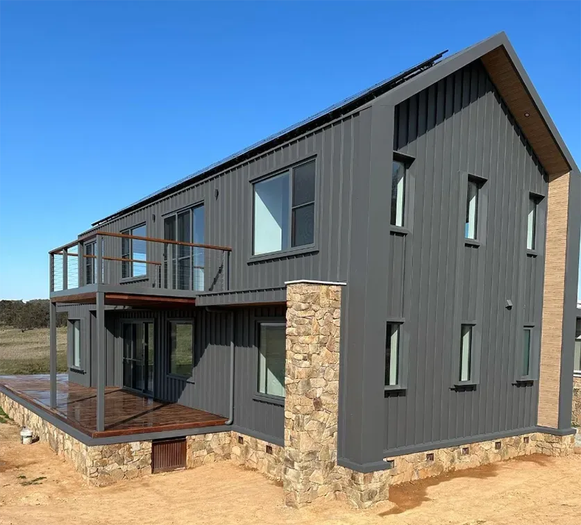 A large gray house with a stone pillar in front of it — Croker Building Solutions In Myrtleville, NSW