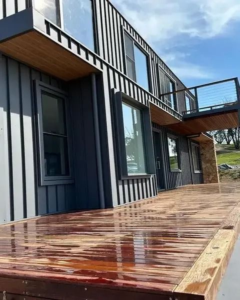 A large house with a wooden deck in front of it. — Croker Building Solutions In Myrtleville, NSW