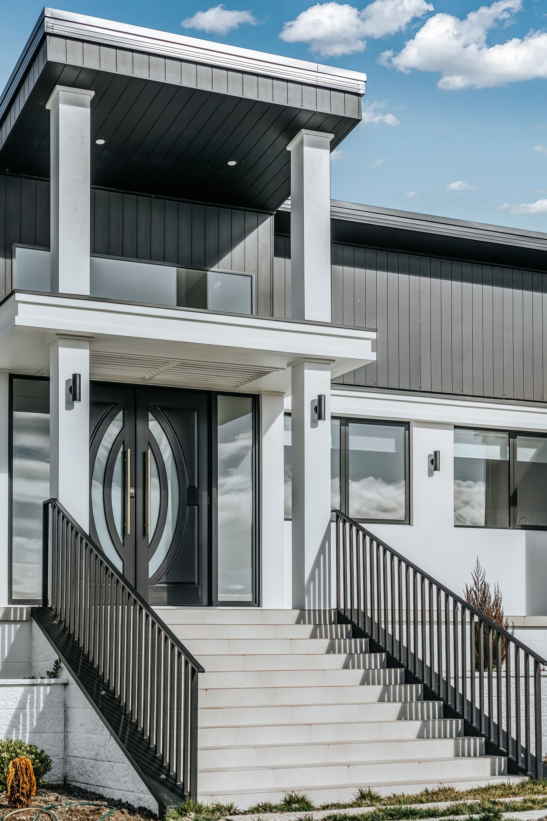A House with A Wooden Door and Stairs Leading up To It — Croker Building Solutions In Myrtleville, NSW