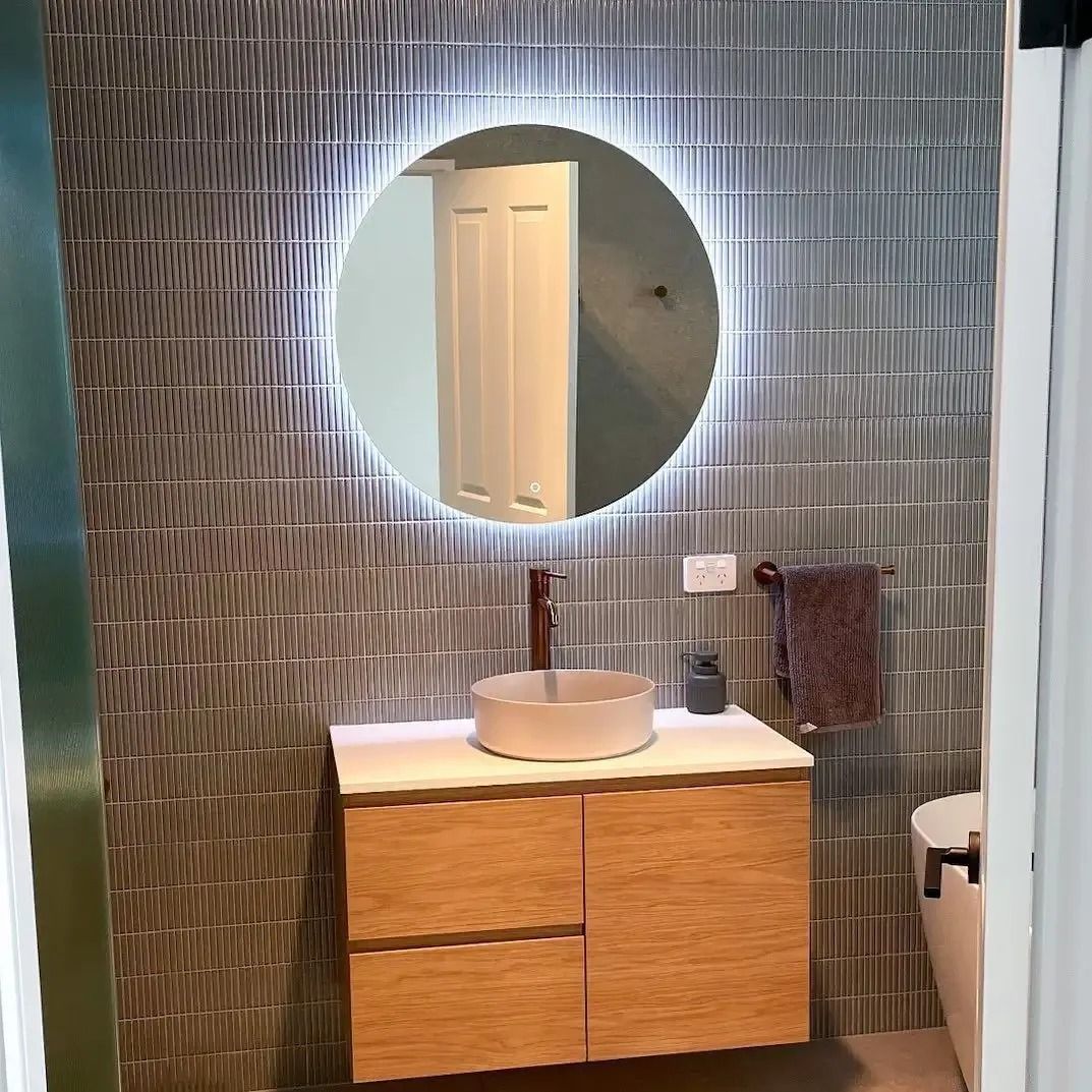 A bathroom with a sink , mirror and toilet. — Croker Building Solutions In Myrtleville, NSW