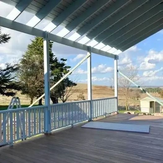 A Wooden Deck with A White Railing and A View of A Field — Croker Building Solutions In Myrtleville, NSW
